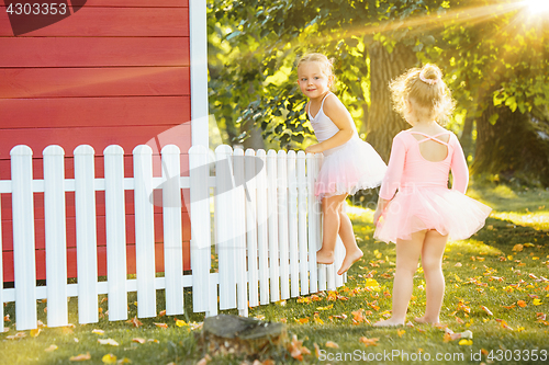 Image of The two little girls at playground against park or green forest