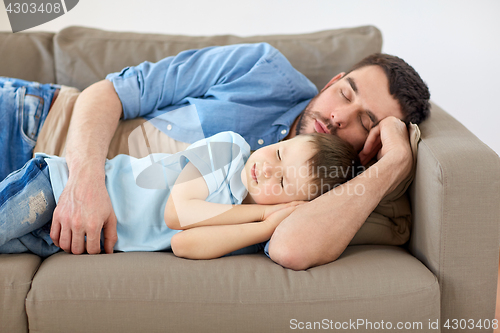 Image of happy father and son sleeping on sofa at home