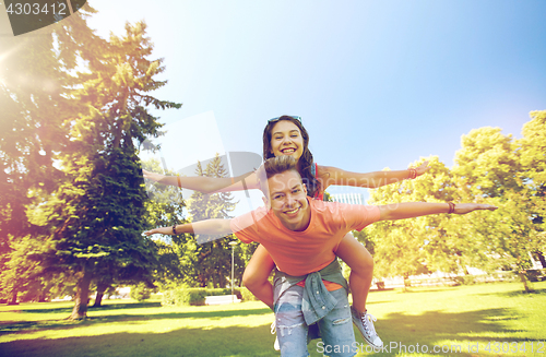 Image of happy teenage couple having fun at summer park