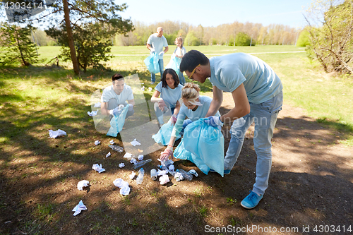 Image of volunteers with garbage bags cleaning park area