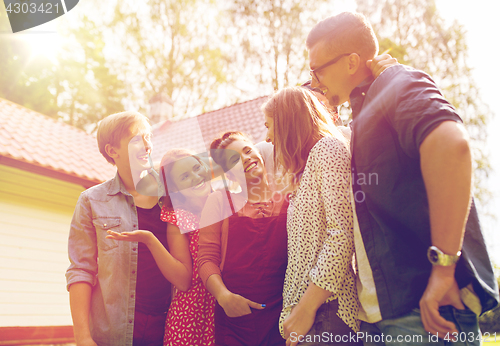 Image of happy teenage friends talking at summer garden