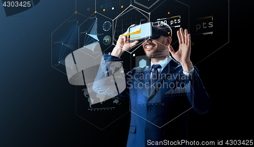 Image of businessman in virtual reality headset over black