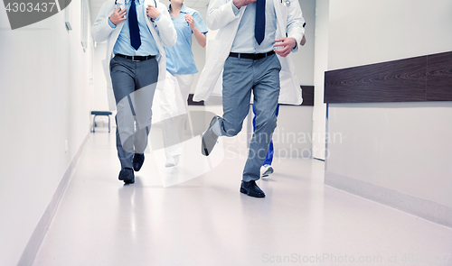 Image of close up of medics or doctors running at hospital