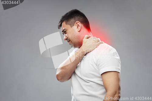 Image of unhappy man suffering from neck pain