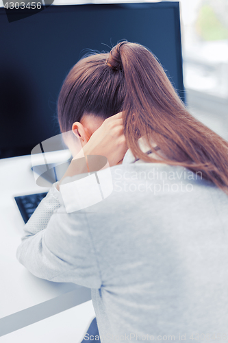 Image of stressed woman with computer