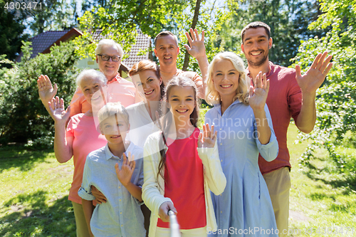 Image of happy family taking selfie in summer garden