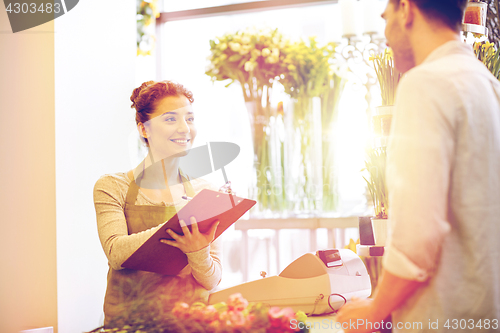 Image of florist woman and man making order at flower shop