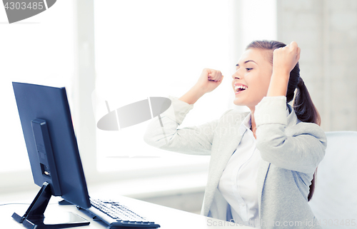 Image of businesswoman with computer in office