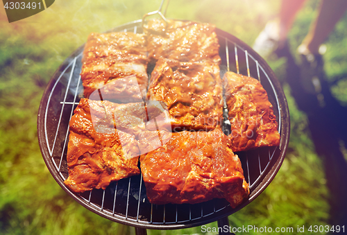 Image of meat cooking on barbecue grill at summer party