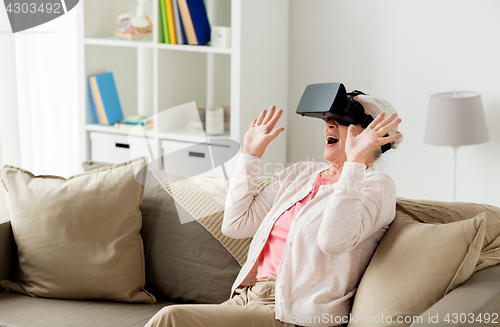 Image of old woman in virtual reality headset or 3d glasses