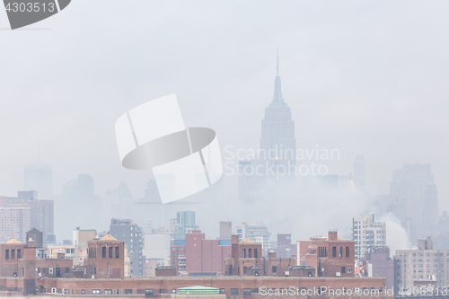 Image of Misty New York City Manhattan skyline with Empire State Building.