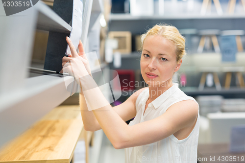 Image of Woman shopping for furniture, sofa and home decor in store.