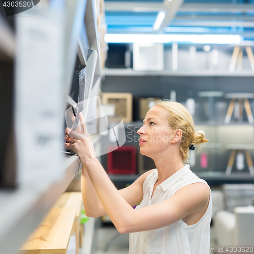 Image of Woman shopping for furniture, sofa and home decor in store.