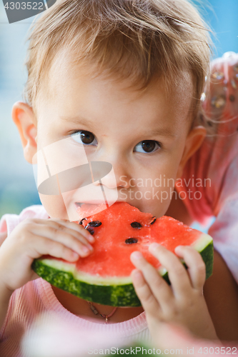 Image of Child eating watermelon