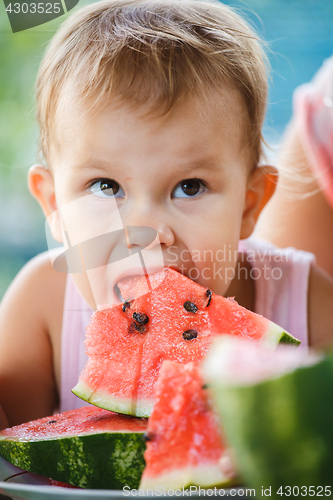 Image of Child eating watermelon