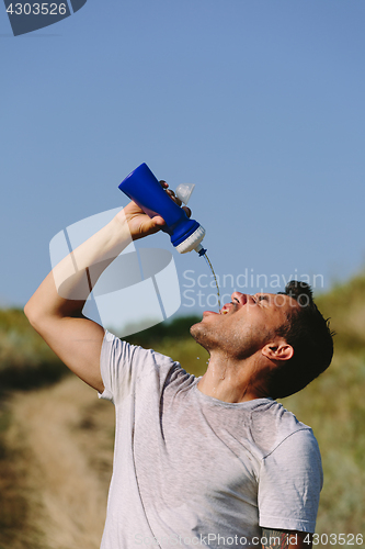 Image of Thirsty person drinking water on nature