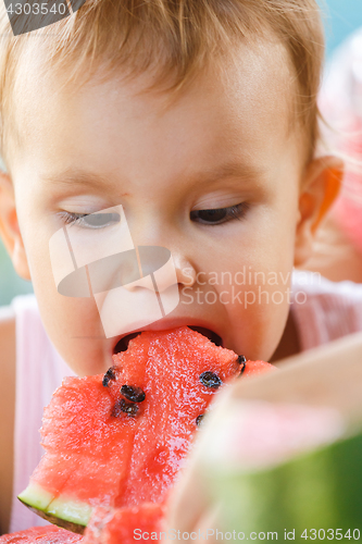 Image of Child eating watermelon