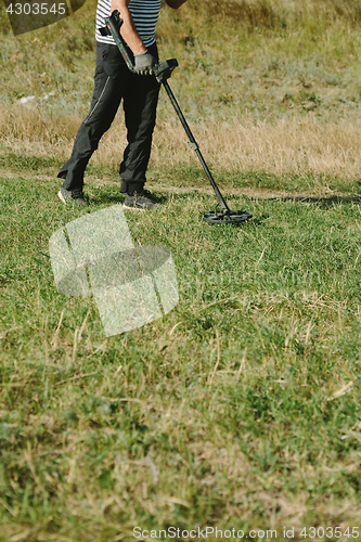 Image of Person with metal finder on nature