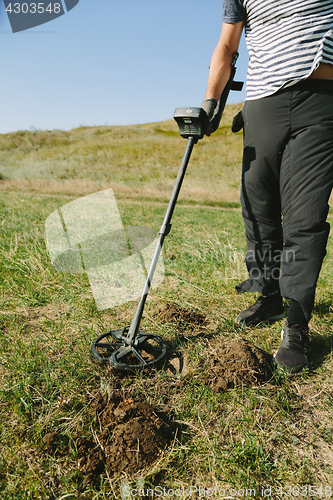 Image of Person with metal finder on nature