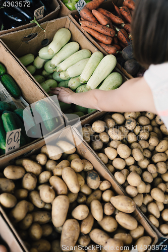 Image of Crop person buying vegetables