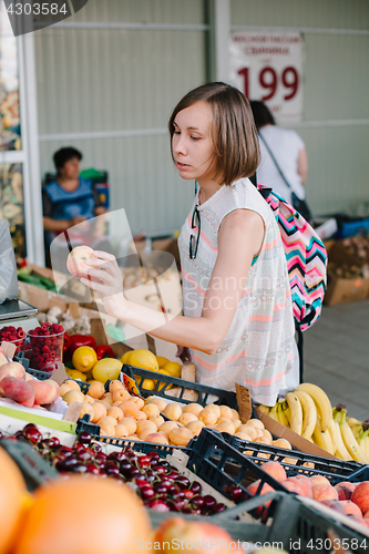 Image of Girl making purchases in outside market