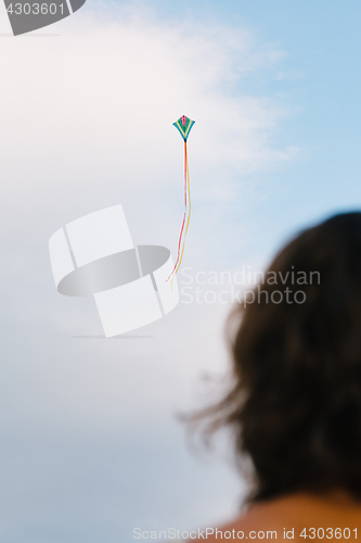 Image of Girl watching kite flight