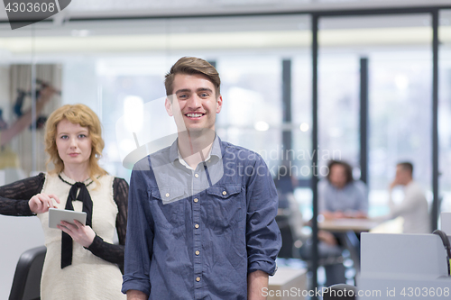 Image of Business People Working With Tablet in startup office