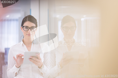 Image of Business Woman Using Digital Tablet in front of startup Office