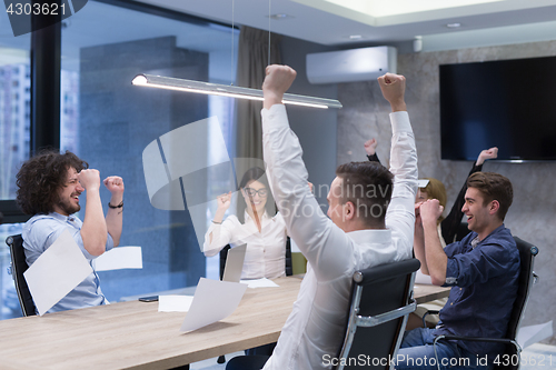 Image of startup Group of young business people throwing documents