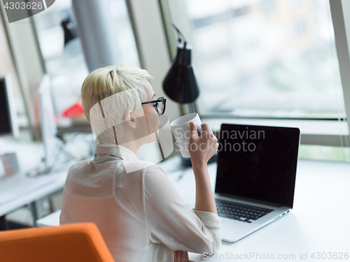 Image of businesswoman using a laptop in startup office