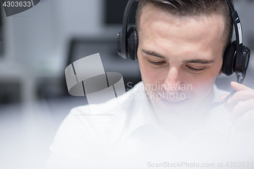 Image of male call centre operator doing his job