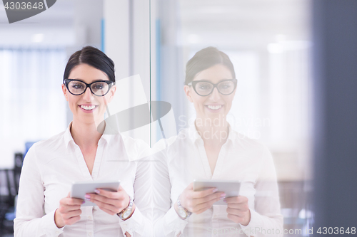 Image of Business Woman Using Digital Tablet in front of startup Office