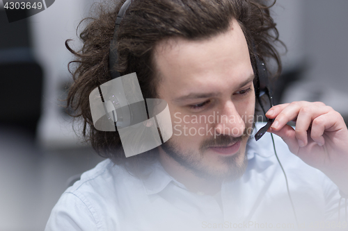 Image of male call centre operator doing his job