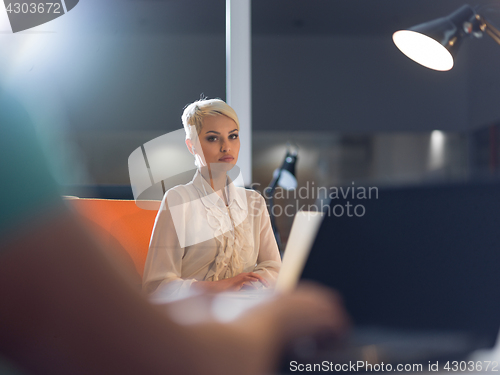 Image of woman working on laptop in night startup office