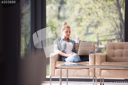 Image of woman drinking coffee enjoying relaxing lifestyle