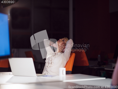 Image of woman working on laptop in night startup office