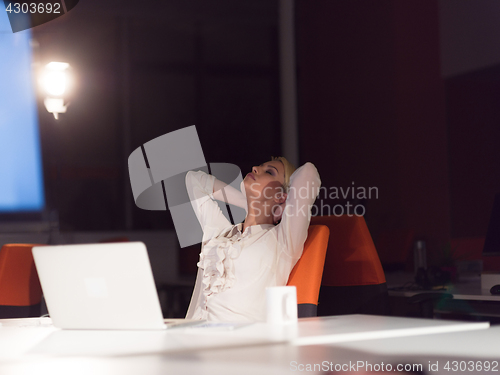 Image of woman working on laptop in night startup office