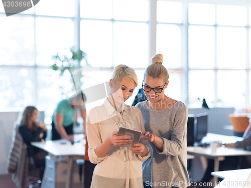 Image of Pretty Businesswomen Using Tablet In Office Building during conf