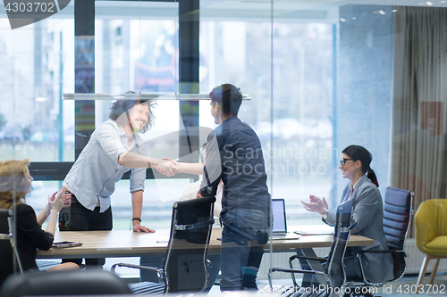 Image of cloasing the deal in modern office interior