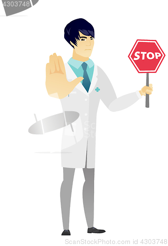 Image of Asian doctor holding stop road sign.