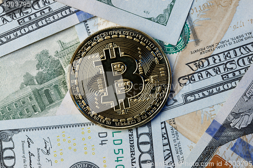 Image of Photo bitcoin on dollar bills