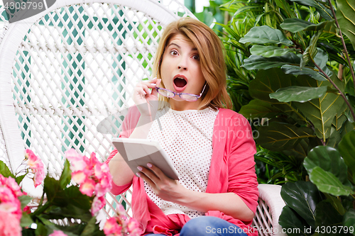 Image of Beautiful surprised woman with tablet