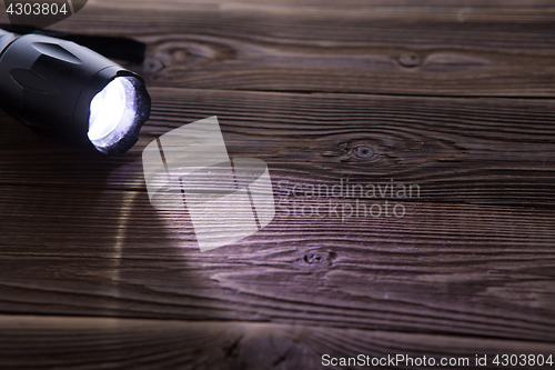 Image of Wooden background with flashlight on