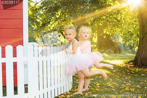 Image of The two little girls at playground against park or green forest