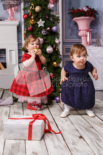Image of The two little girl standing at studio with christmas decorations
