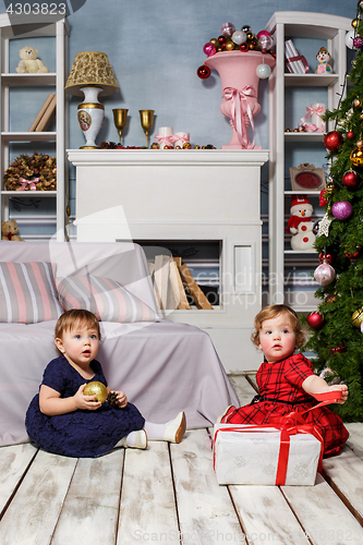 Image of The two little girls sitting at studio with christmas decorations