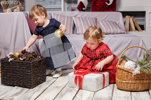 Image of The two little girls with gifts at studio with christmas decorations