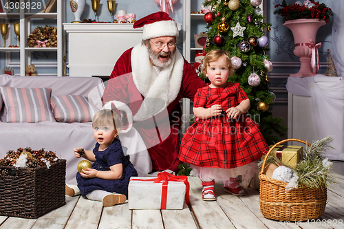 Image of The two little girls with Santa at studio with christmas decorations