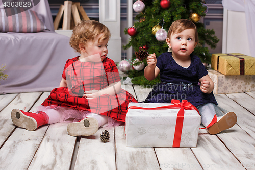 Image of The two little girls sitting at studio with christmas decorations