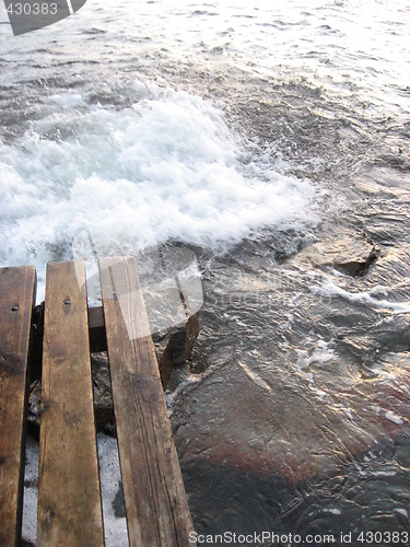 Image of Wooden steps into stird up water